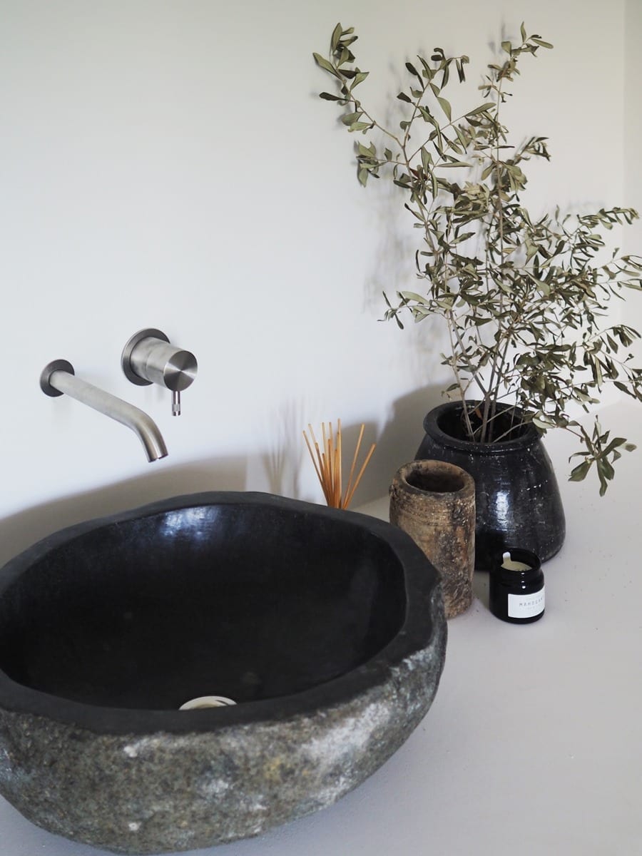 Minimalist bathroom design and stone sink at Villa Son Font in Mallorca, Spain