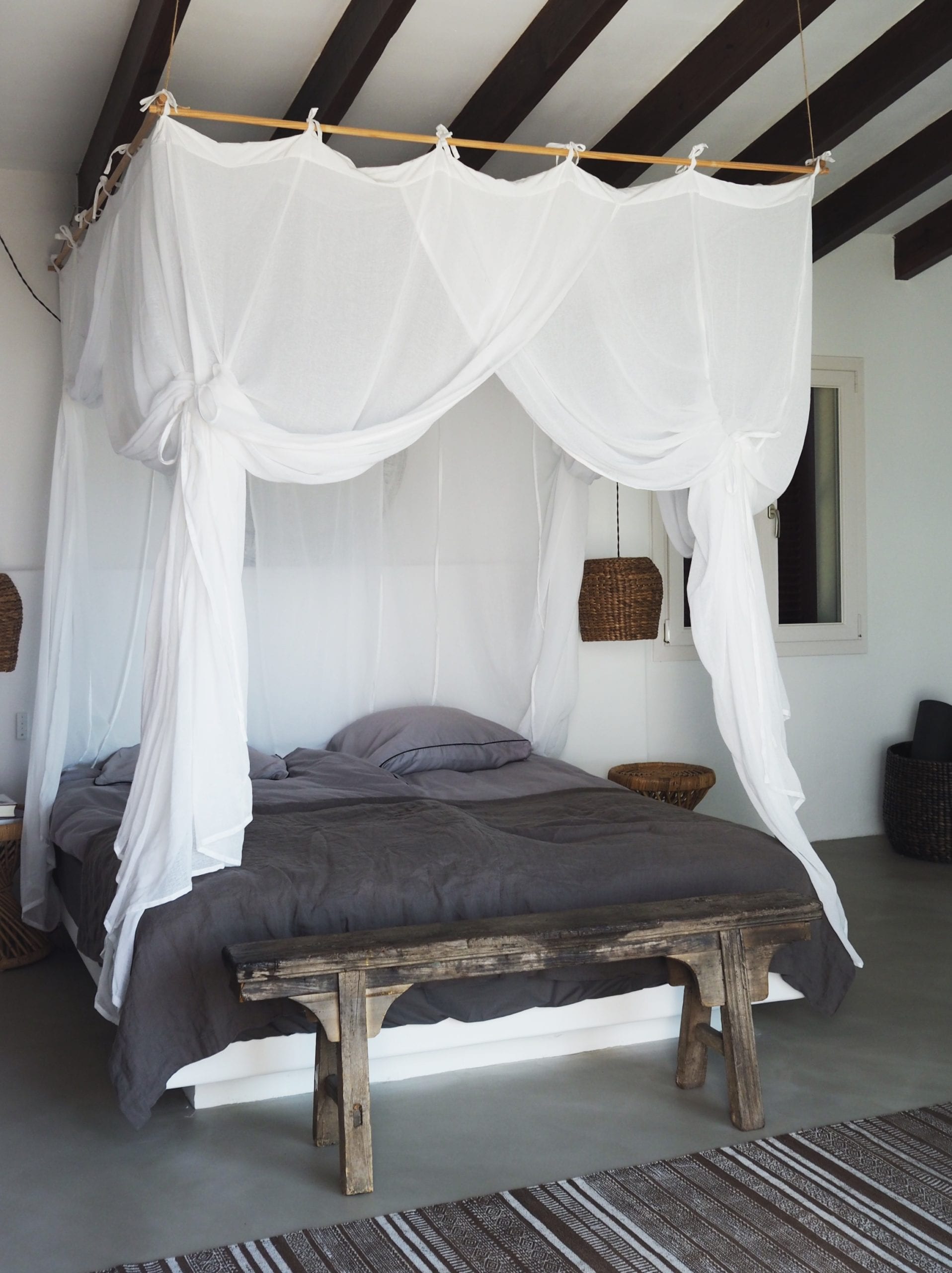 Rustic minimalism bedroom design with beautiful canopy at Villa Son Font in Mallorca, Spain